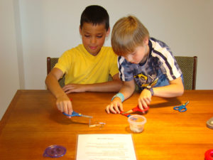 two children exploring magnetism